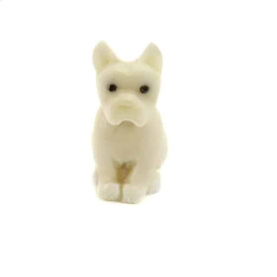 a hand carved boxer tagua nut on a white background