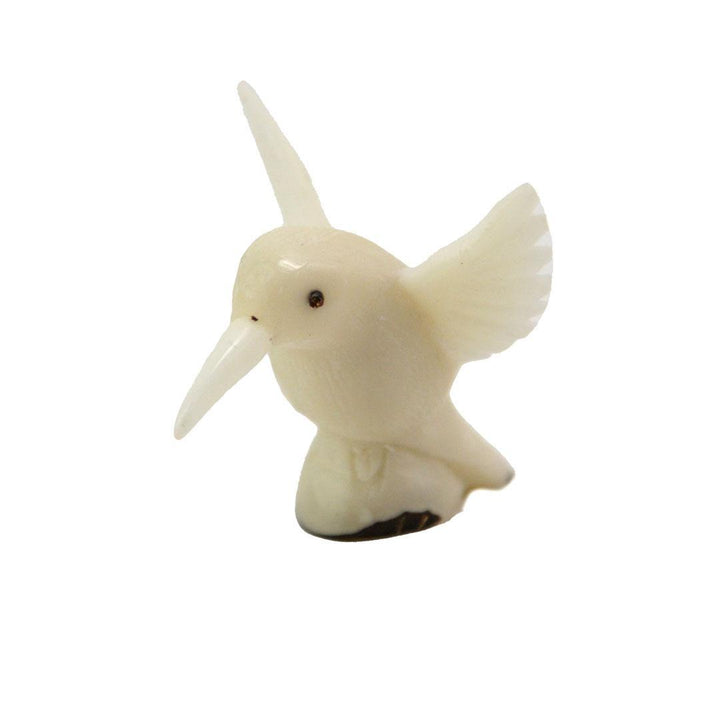 hand carved tagua nut hummingbird on a white background.