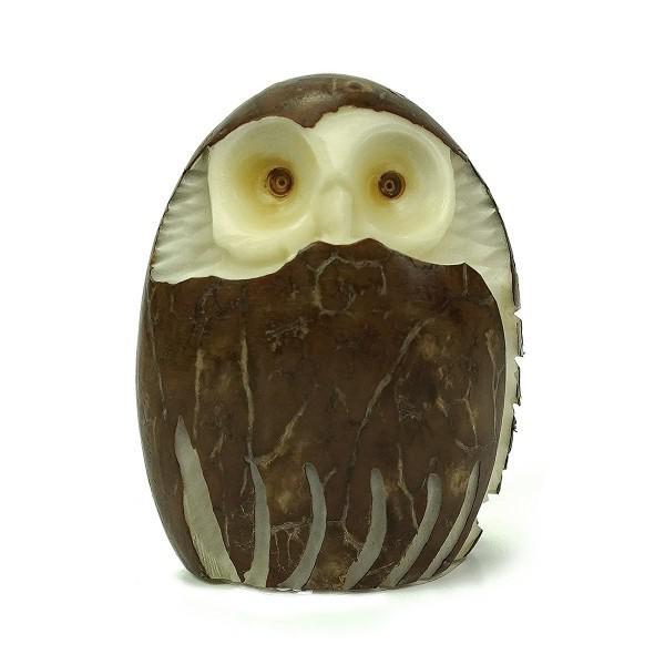 Decorative owl-shaped tagua nut with brown and white colors on a white background