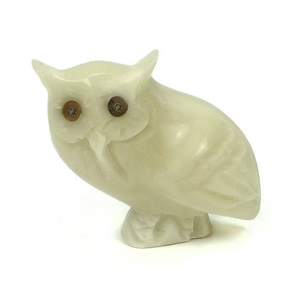 White owl carved tagua nut on a white background
