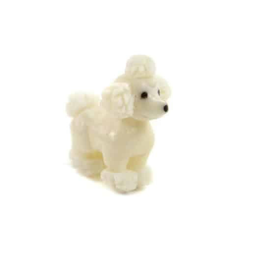 a hand carved tagua nut poodle on a white background