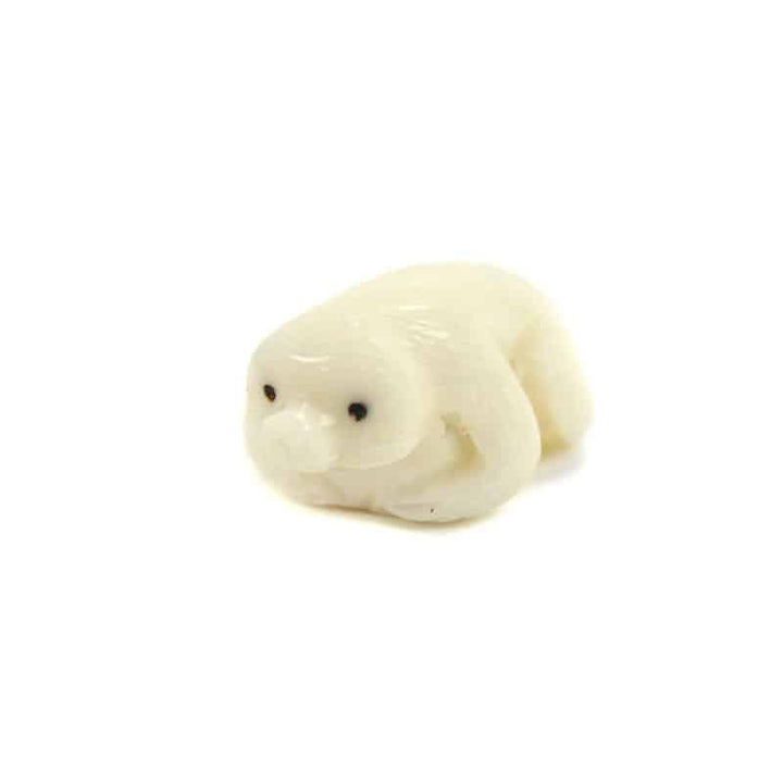A hand-carved white tagua nut figurine of a sloth