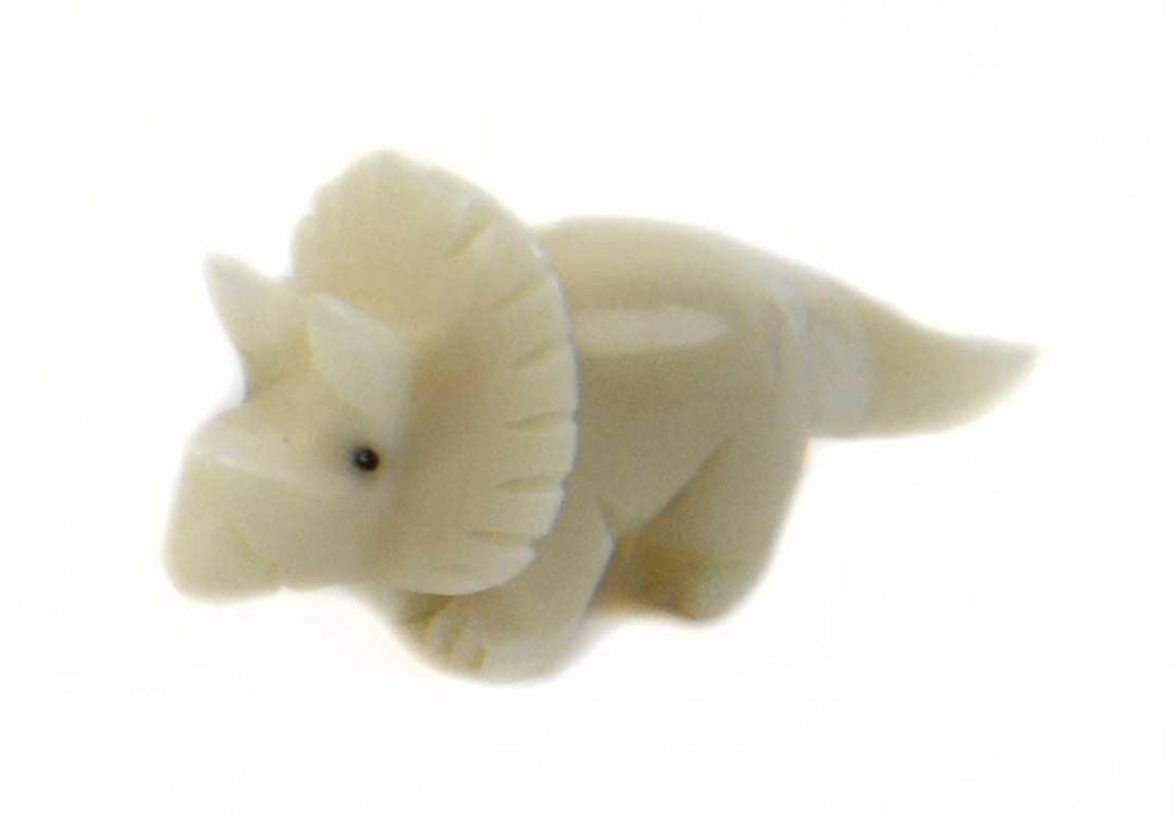 A tagua nut triceratops on a white background