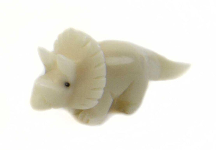 A tagua nut triceratops on a white background