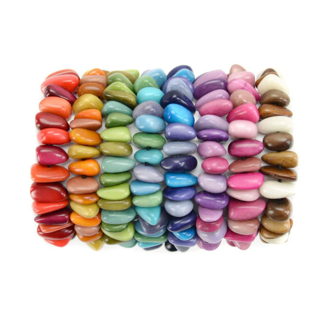 A multicolored stretch bracelet made from tagua nut, featuring a variety of shapes and colors.