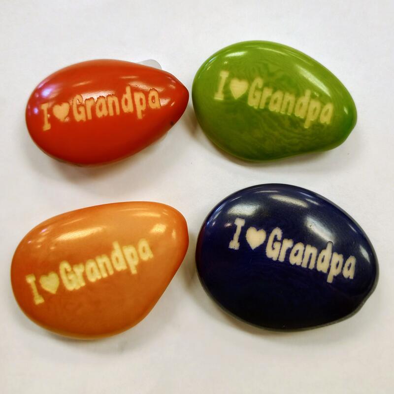 Four colorful tagua nuts with 'I ❤️ Grandpa' text on a white background