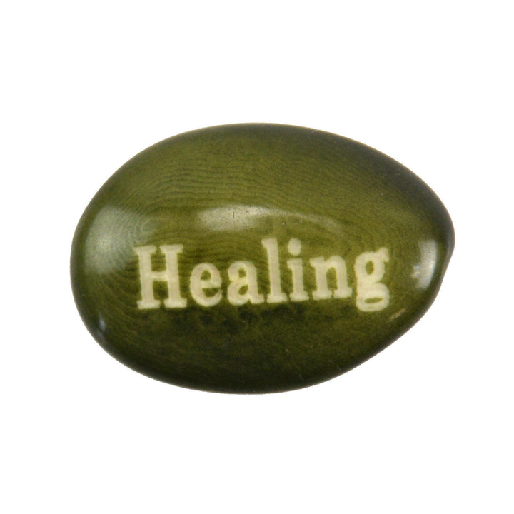 Green tagua nut with 'Healing' engraved on a white background