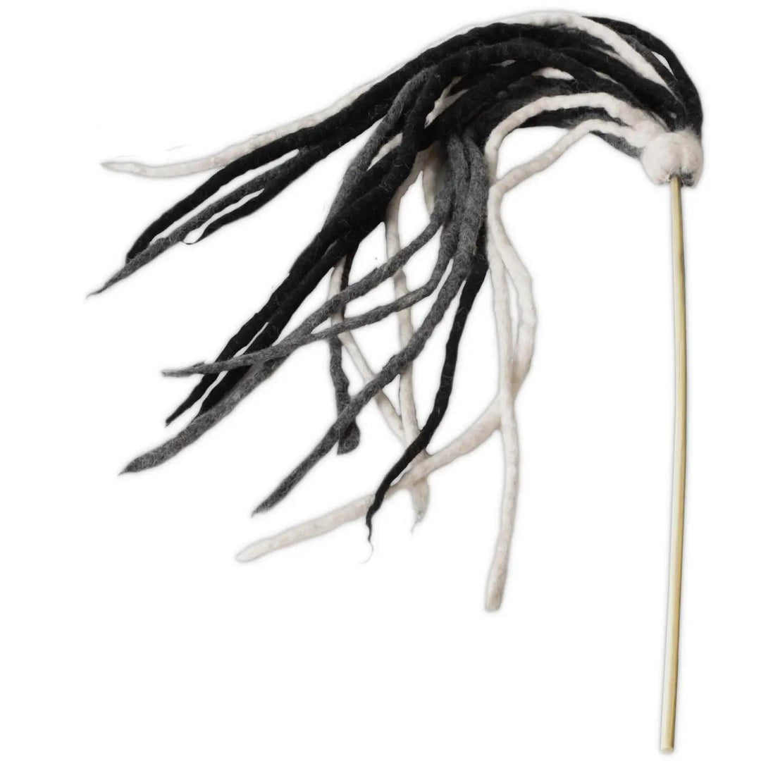 Black and white feathered cat toy on a stick against a white background