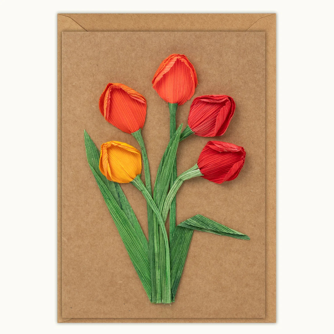 Card with red and orange tulips on a brown background