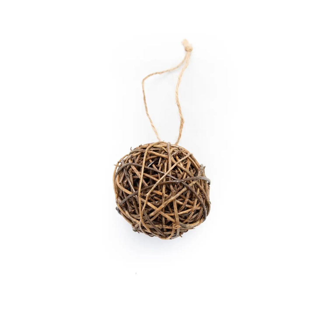 A small decorative ball ornament made from tightly woven natural twigs, suspended by a thin jute string on a plain white background.