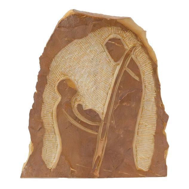 Decorative stone with engraved design of a woman and child, possibly a nativity scene, on a white background.