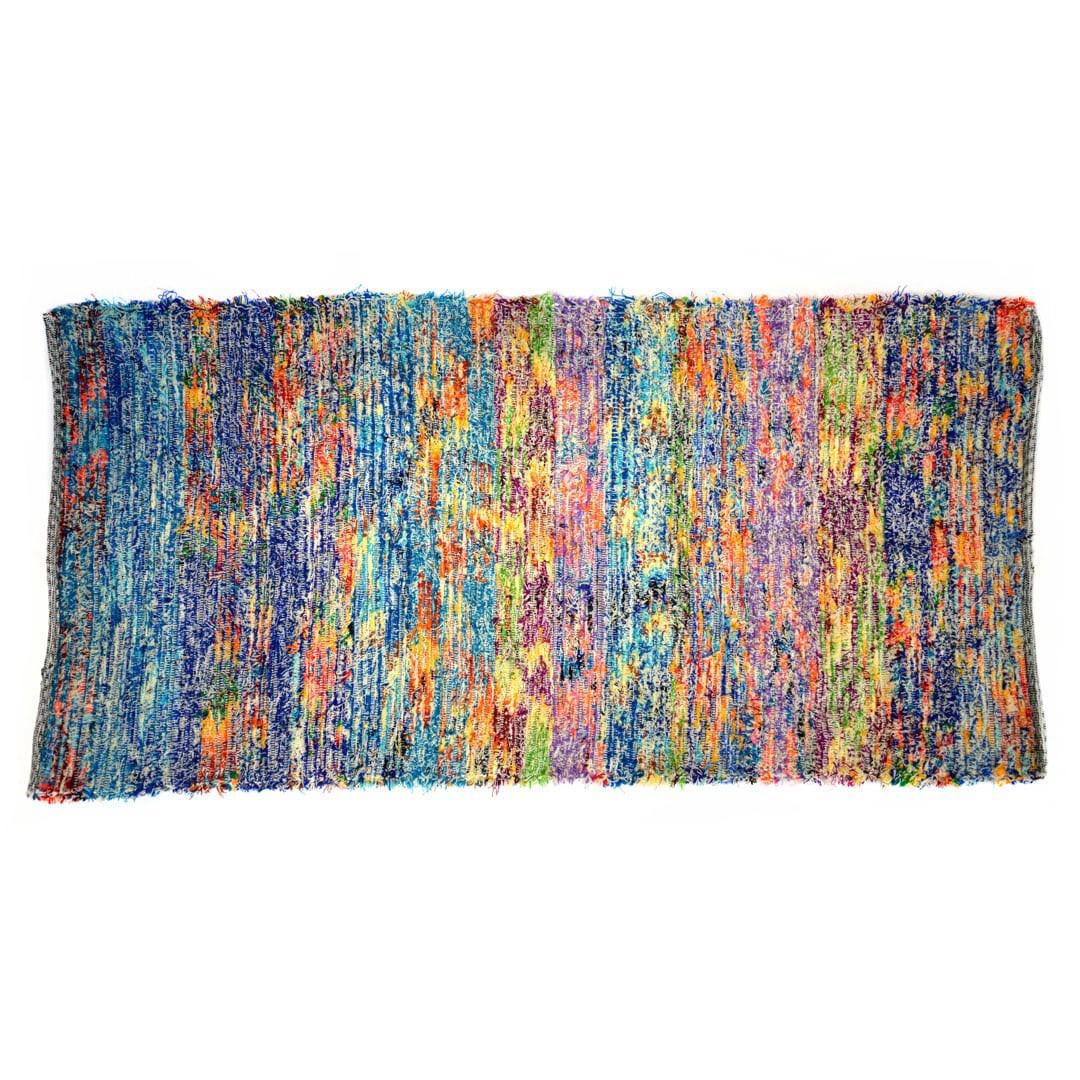 A multicolored upcycled fabric rug with a textured pattern.