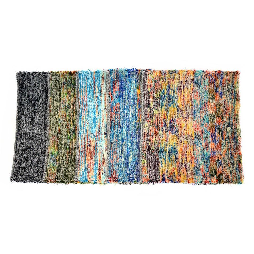 Multicolored upcycled fabric rug on white background. 