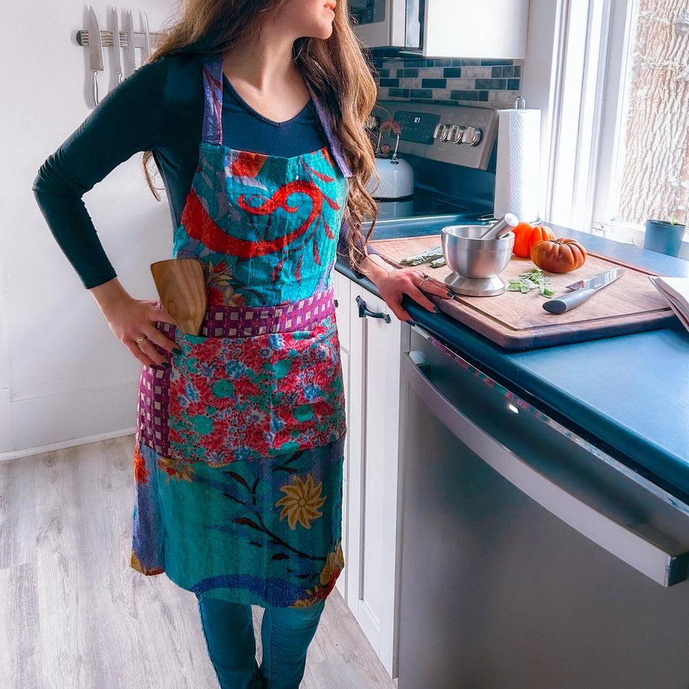 Woman wearing handmade upcycled kantha apron in the kitchen. 