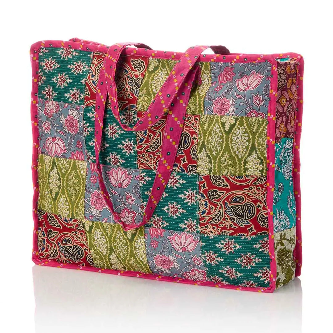 Colorful patchwork tote bag with floral and paisley patterns on a white background