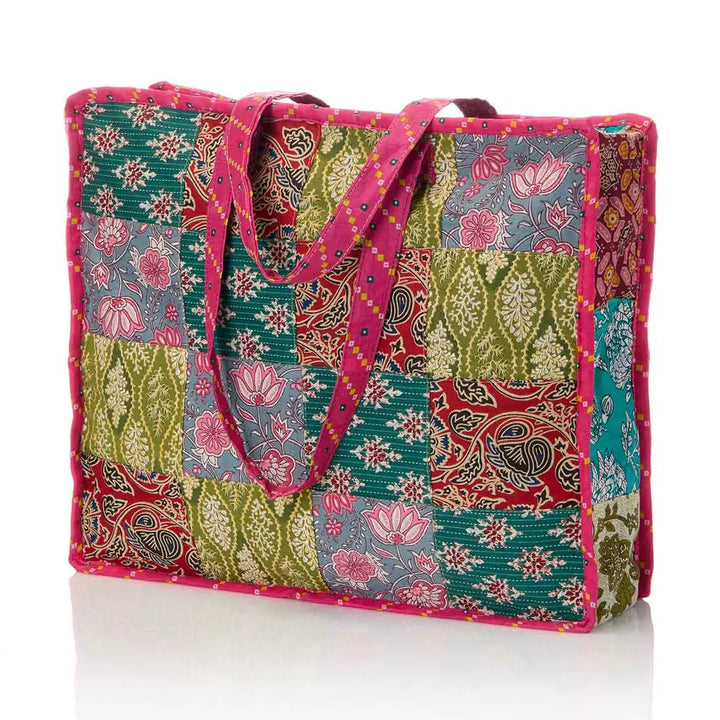 Colorful patchwork tote bag with floral and paisley patterns on a white background