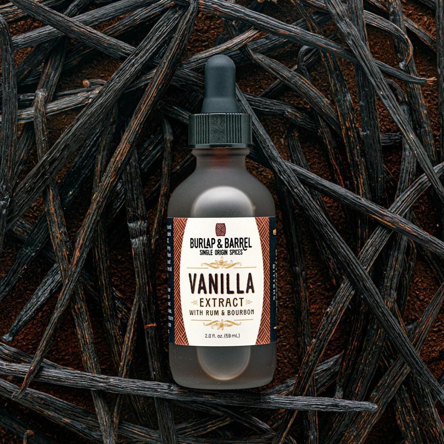 Bottle of Vanilla Extract with Rum & Bourbon by Burlap & Barrel on a dark background