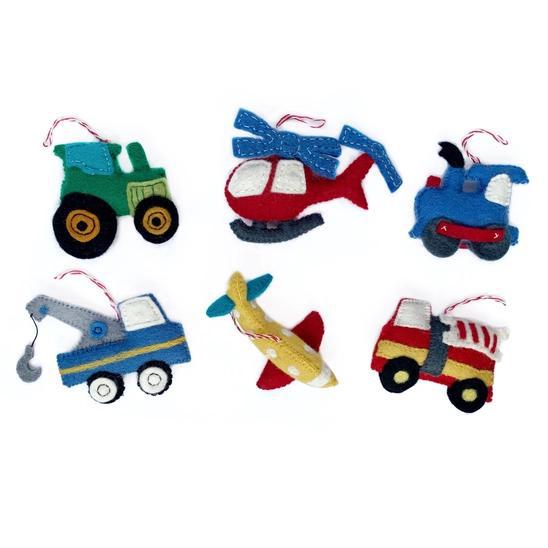 A set of handmade felt ornaments in various vehicle shapes, including a car, truck, helicopter, shark, and tractor, primarily in colorful blue, green, red, and yellow.