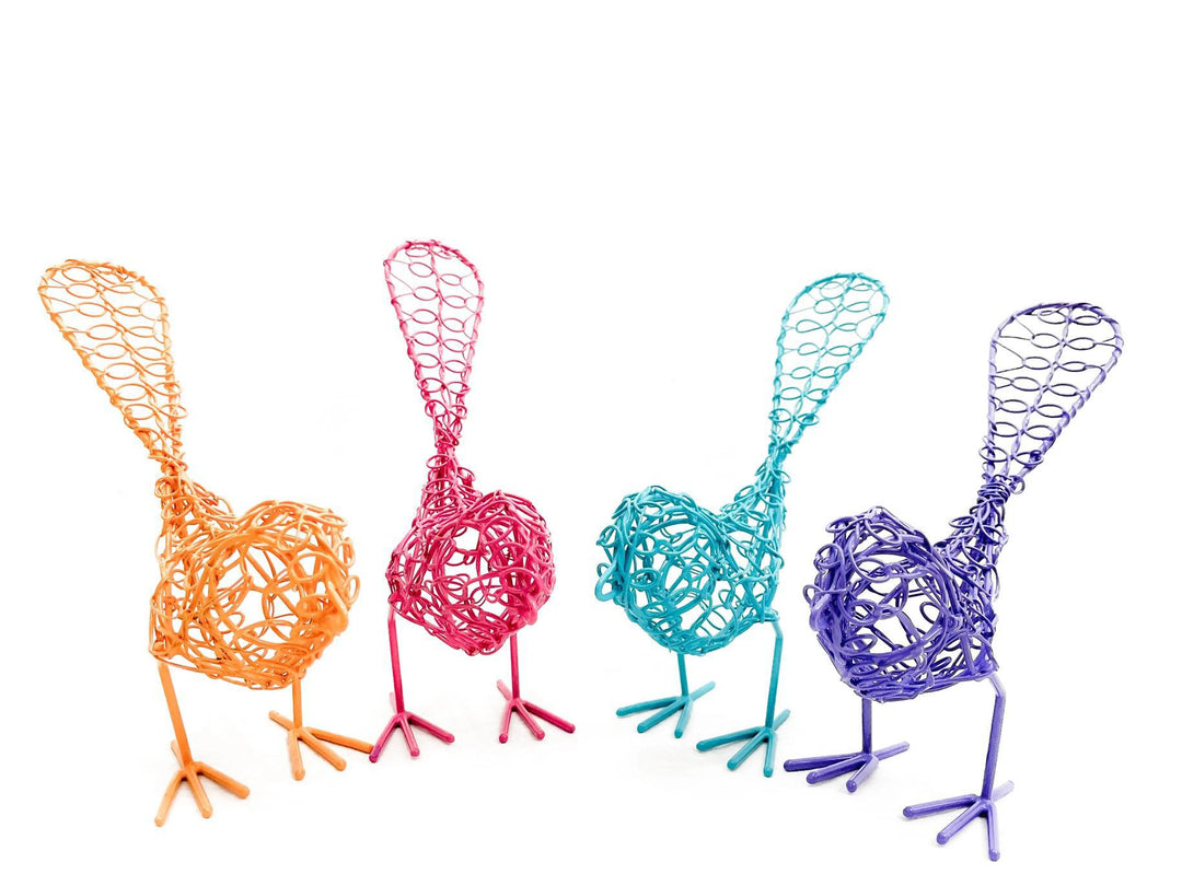 A group of colorful wire birds with outstretched wings in shades of pink, orange, blue, and purple.