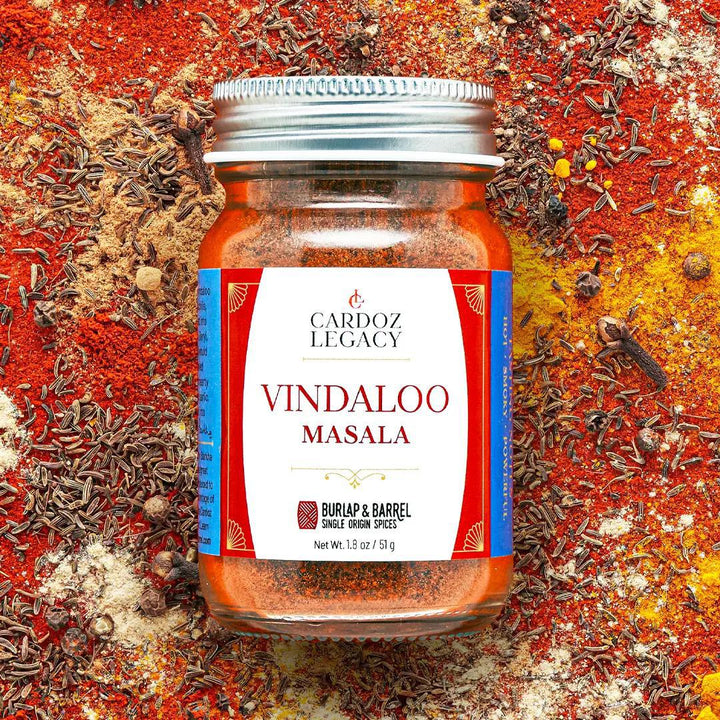 Jar of Vindaloo Masala spice mix with a visible brand label on a colorful background of spices.