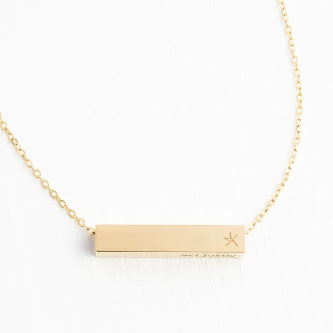 Gold necklace with a bar pendant on a white background