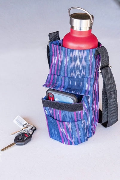 Multifunctional pouch with water bottle holder, phone pocket, and key clip on a white background