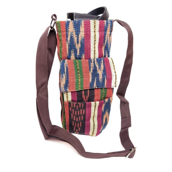 Multicolored patterned bag with brown strap on a white background