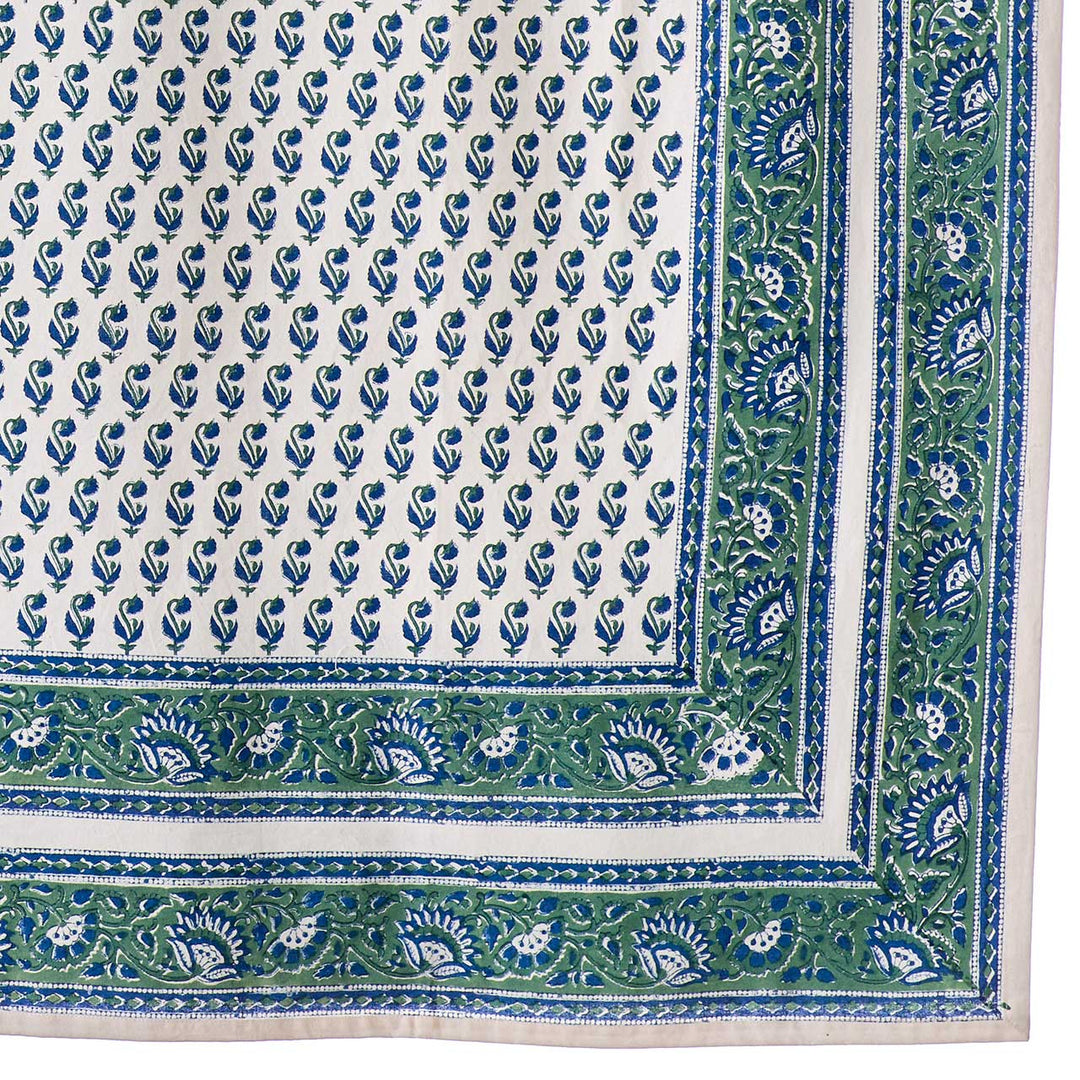 Close-up of a blue and green patterned fabric with a border