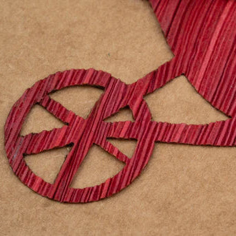 Red cornhusk wheelbarrow on a brown card