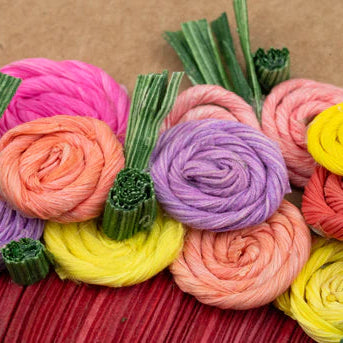Colorful cornhusk flowers on a brown background