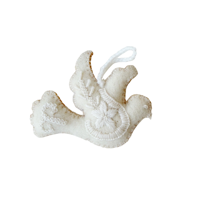A white felt Christmas ornament shaped like a dove with embroidered details and a hanging loop, shown on a plain white background.