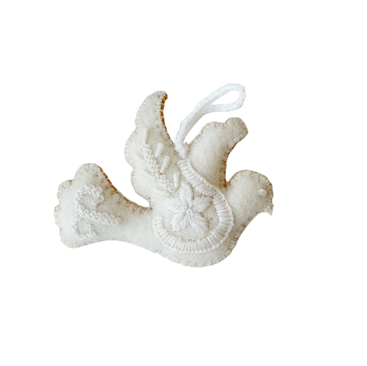 A white felt Christmas ornament shaped like a dove with embroidered details and a hanging loop, shown on a plain white background.
