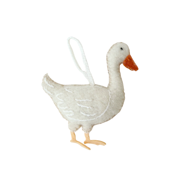 A white felt goose ornament with a stitched white loop at the top for hanging, featuring a bright orange beak and feet.