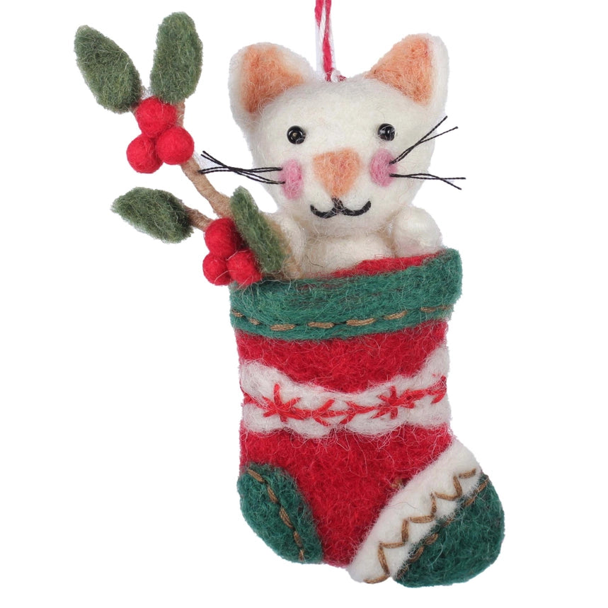 Felted cat ornament in a red and green stocking with holly leaves and berries on a white background.