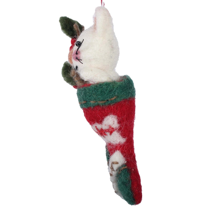 Felted cat ornament in a red and green stocking on a white background