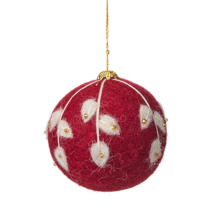 Red felt Christmas ornament with white floral patterns and gold accents on a white background