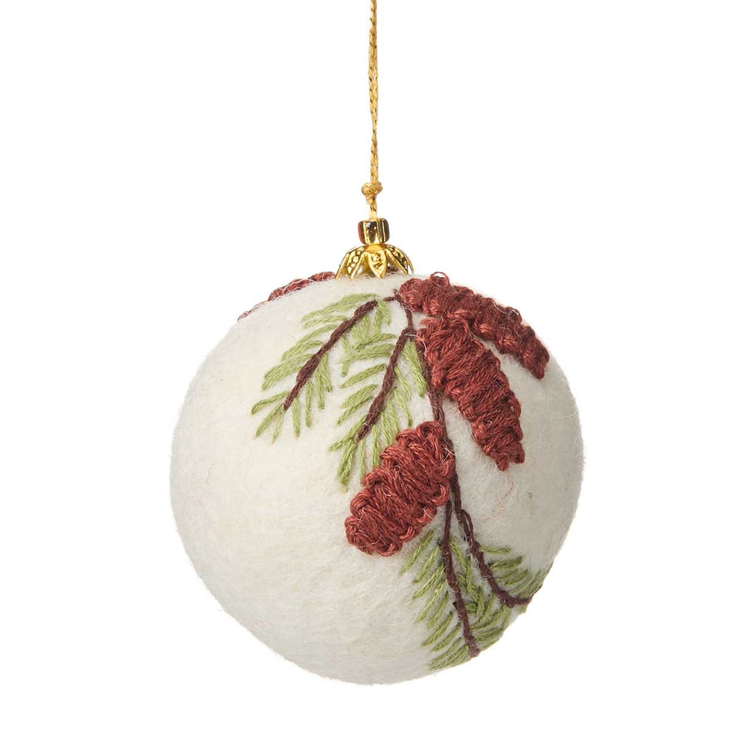 Decorative Christmas felt ball ornament with pine cone and branch design on a white background