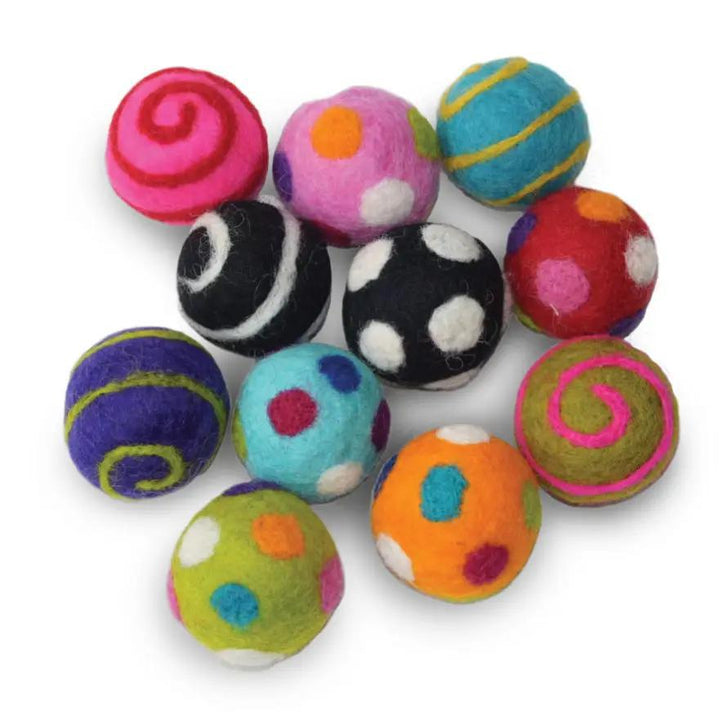 Colorful felted wool ball pet toys with various patterns on a white background