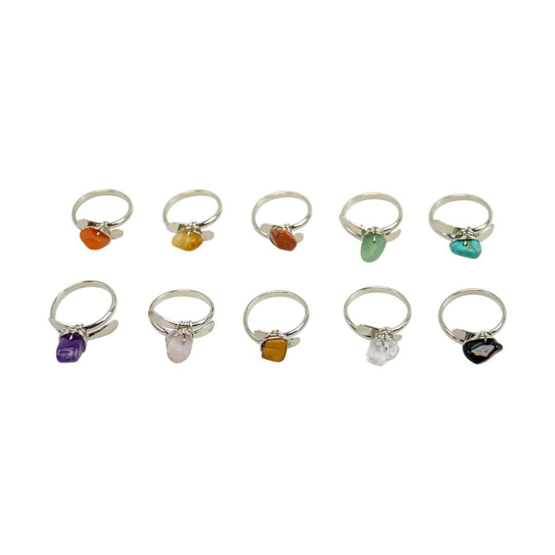 A collection of wrapped stone rings with various colorful semiprecious stones set in silver bands.