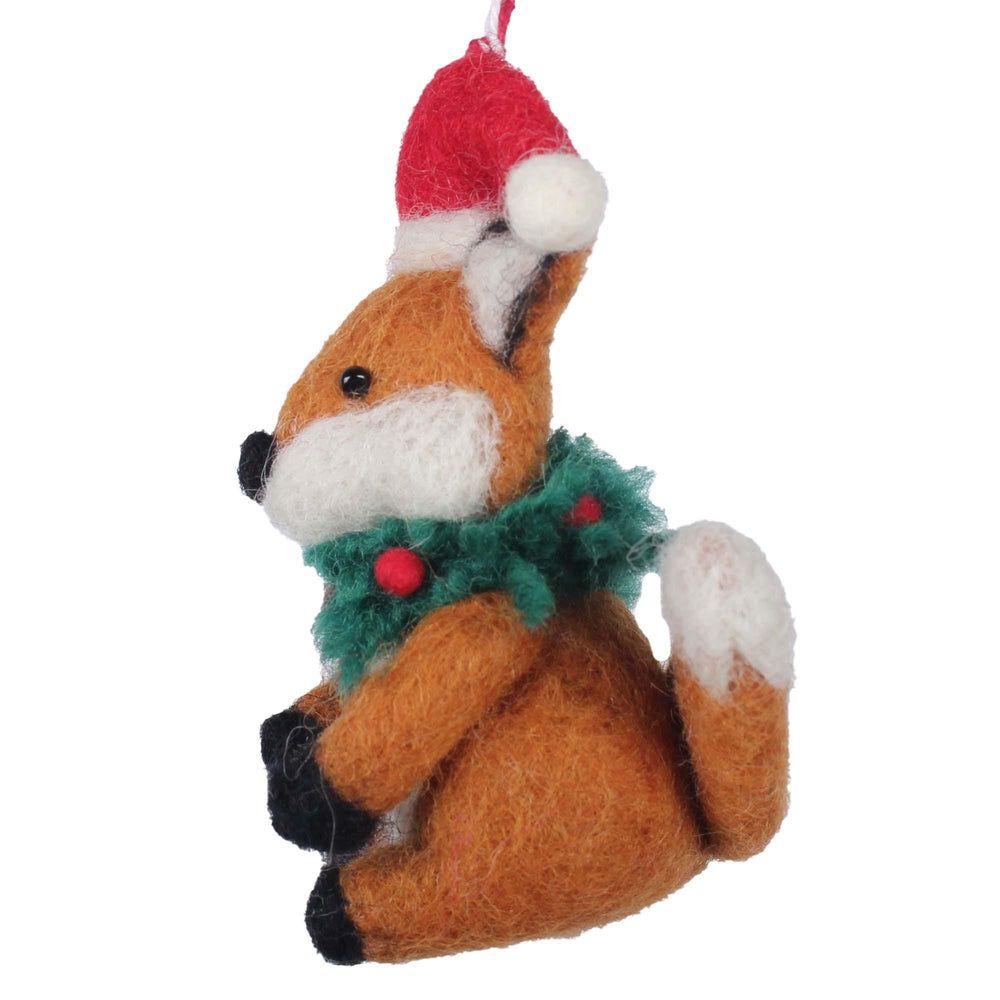 Felt fox ornament with a Santa hat and green wreath on a white background