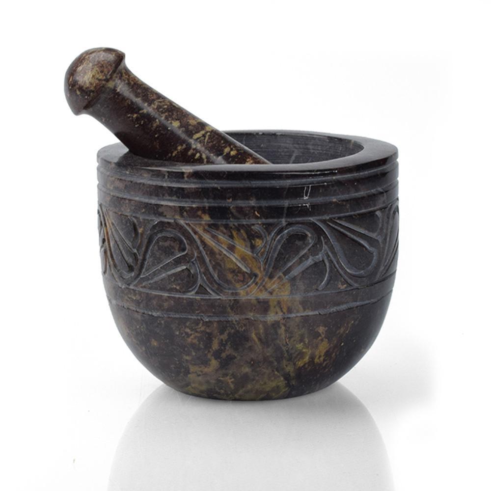 A black and brown etched gorara mortar and pestle on a white background.