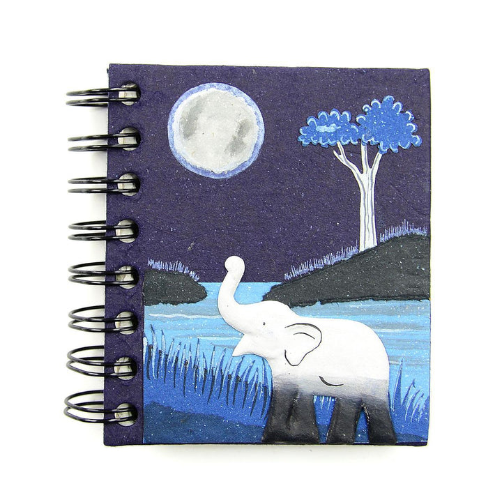 a small spiral notebook with an elephant