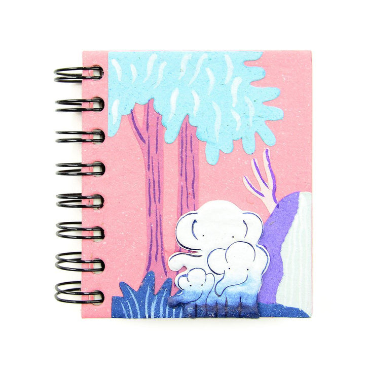 a small spiral notebook with a pink notebook