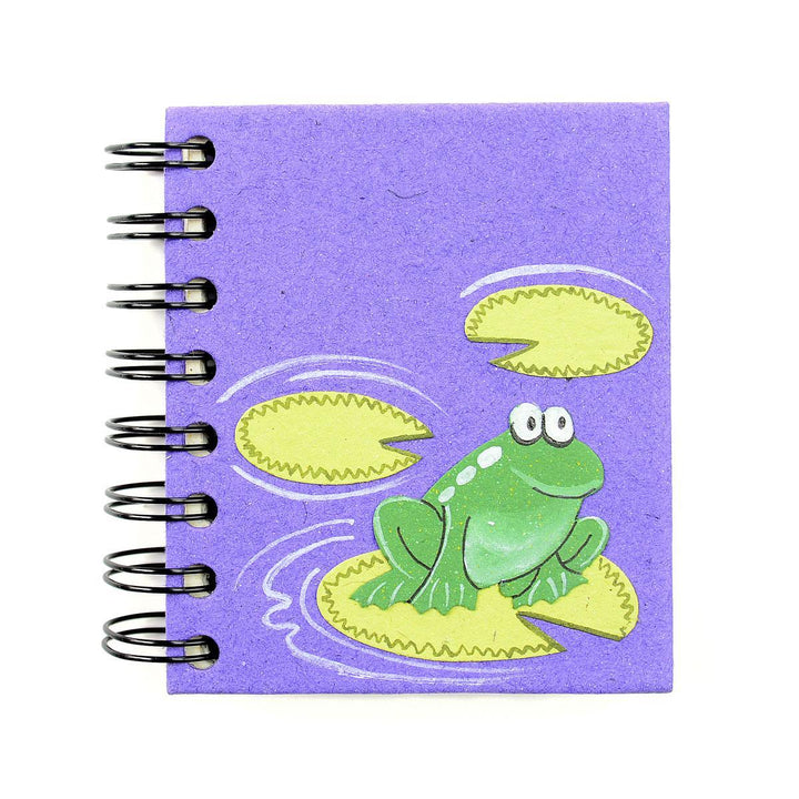 a small spiral notebook with a frog on a lily pad