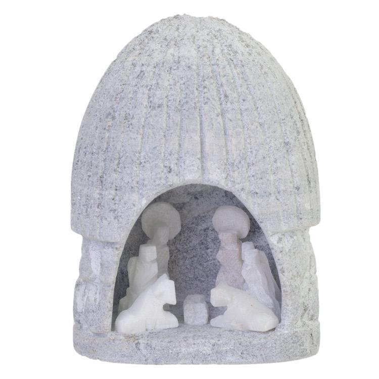 Small nativity scene figurine with a roof carved from alabaster against a white background