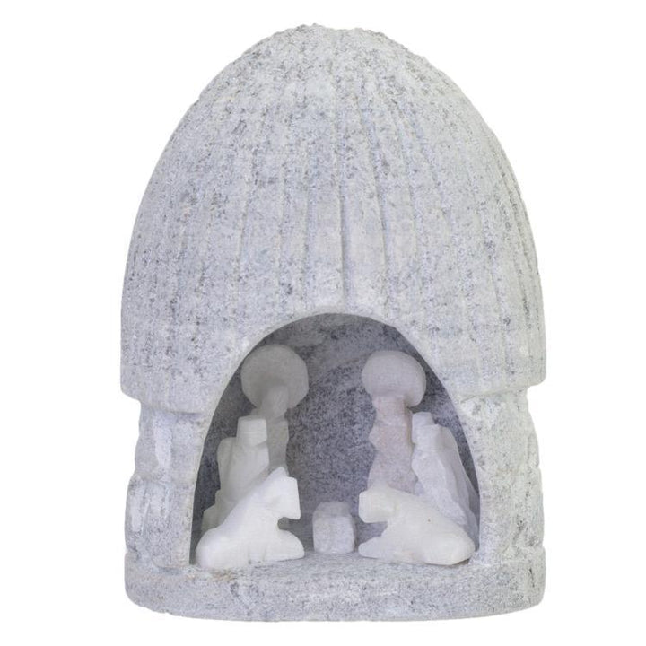 Small nativity scene figurine with a roof carved from alabaster against a white background