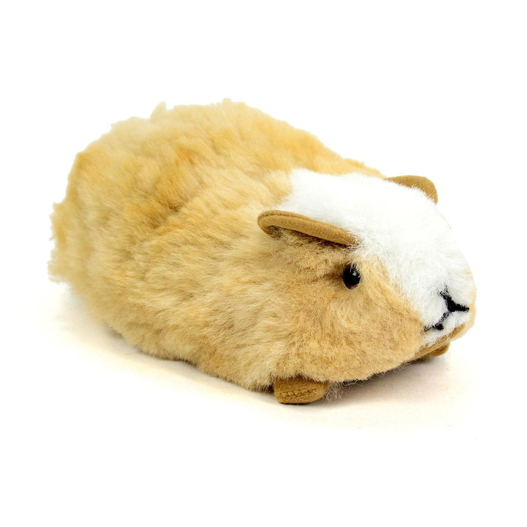 A plush toy resembling a guinea pig with beige alpaca fur, white face, and brown eyes.