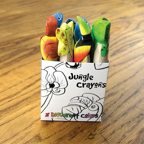 A set of colorful wooden crayons carved and painted to resemble tropical animals, displayed in a box with 'Jungle Crayons' written on it.