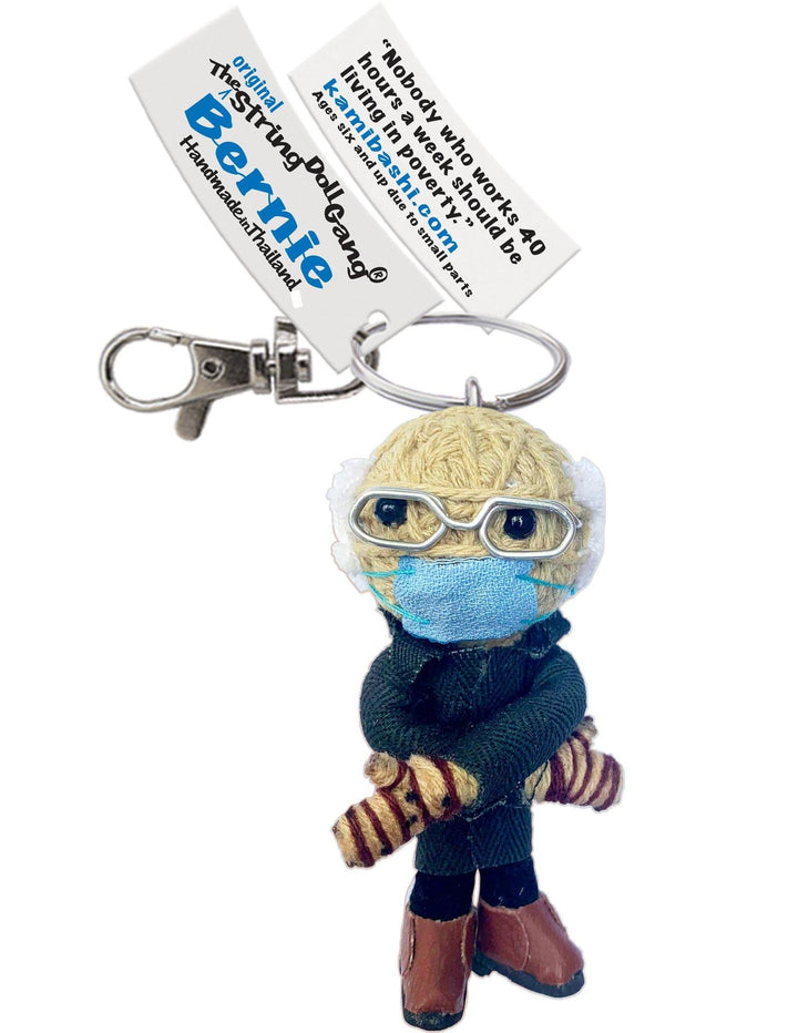 Handmade string doll of Bernie Sanders with his mittens on. Attached to the doll is a nametag and key ring. 