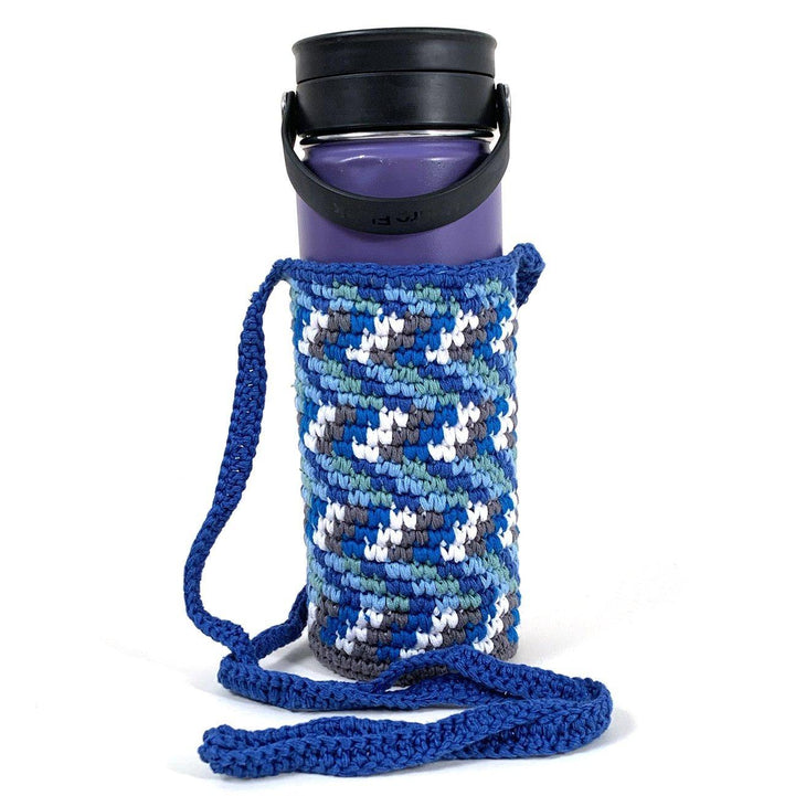 Hand knitted blue water bottle holder with white and gray chevron design with blue shoulder strap.